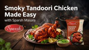 Smoky tandoori chicken on white plate with lemon wedges and onion slices garnish